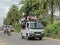 Small pickup truck overloaded with people and goods