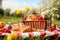 A small picnic blanket with a basket of fruits and sandwiches on spring flowers field, spring time,