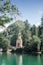 Small picturesque lakeside church, small chapel chapel on the beach. Chapel in the woods. A secluded religious place.