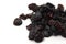 Small pile of black raisins on a white backgr