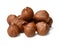 A small pile of peeled hazelnuts on a white isolated background. Side view.Macro