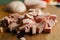 A small pile of sliced sausage for cooking on a wooden table