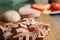 A small pile of sliced sausage for cooking on a wooden table