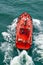 Small pilot boat sailing with waves