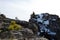 Small pine tree on a rocks with mountains on a background