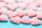 Small Pink Sugar Candy Sprinkles Spilled Scattered on Light Blue Background. Selective Focus. Pattern Template for Valentine