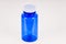 Small plastic blue vial bottle filled isolated over the white background