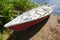 Small plastic red and white rowboat