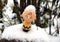 Small plastick smiling toy covered with snow