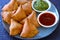 Small plate of Samosa with tomato sauce