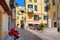 Small plaza among colorful houses in Ventimiglia, Italy.