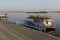 Small pleasure boat and a river pier on water surface