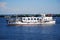 A small pleasure yacht rides tourists on a summer day on the Neva Bay.