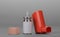 Small pocket inhaler and bottle with dispenser on gray