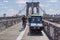 A small police electric car on the footpath of the Brooklyn Bridge.