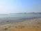 Small polluted beach at Mumbai marine drive with view of mumbai city