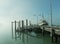 Small port with parked boats along the dock on a foggy day in New Zealand