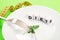 Small portion of food on big plate close-up. Small green parsley leaf on white plate with fork and knife and text diet on the