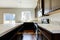 Small yet practical kitchen with black cabinets and tile marble tops.