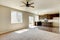 Small yet practical kitchen with brown cabinets and hardwood flooring.