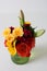 Small pretty vase with bright and colorful arrangement of flowers