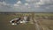 A small private farm taken from a bird`s-eye view. Video agricultural land with drone or quadrocopter. Silos, tractors and hangars