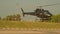 A small private helicopter lands at an airfield in Dubai