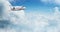 Small private jetplane flying above beautiful clouds.