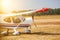 A small private plane with propeller stands at the airport, in bright, sunny day.