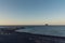 The small promontory of Strombolicchio from Stromboli`s black beach at sunset in Sicily, Italy