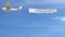 Small propeller airplane towing banner with DISCOVER caption in the sky