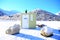 A small public toilet on the top of a snowy mountain.