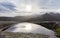 A small puddle of water with reflections on a mountain in Galicia.