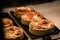 Small puff pies with vegetables and meat, quiches in a cafe window.