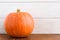 Small pumpking on wooden background and copy space