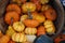 Small pumpkins and squash in a basket for sale