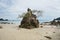 A small quartzite mountain on the sandy beach.