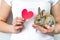 A small rabbit and a heart in human hands. The concept of animal protection and conservation. Bunny close-up in the palm