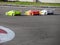 Small radio controlled model cars on the track . Miniature remote controlled sport racing cars hobby