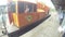 Small railway diesel freight locomotive with crews onboard stationed at the passenger terminal. Tracking shot