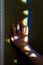 Small rainbows made of refracted light illuminate a child`s hand