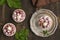 Small raspberry cheesecakes over grunge wooden table