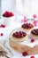 Small raspberry tarts on bright background