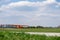 Small red charter airplane waiting on a green field to take off