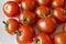 Small red cherry tomatoes on a plate in a group