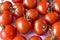 Small red cherry tomatoes on a plate in a group