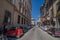 Small red electric car on street Borgo Ognissanti in Florence