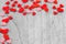 Small red hearts putting on monochrome wooden background