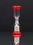 Small red hourglass with white sand and reflexion