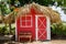 Small red house with palm leaves roof